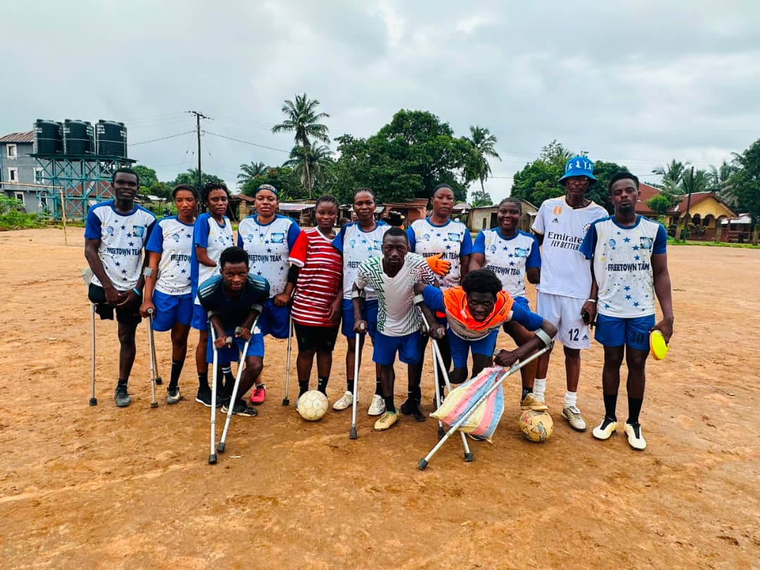 Male and female disabled athletes pose together